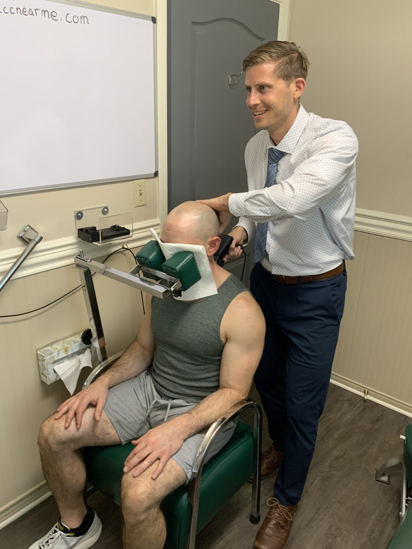Dr. Marsh giving a gentle Blair upper cervical adjustment to a seated patient