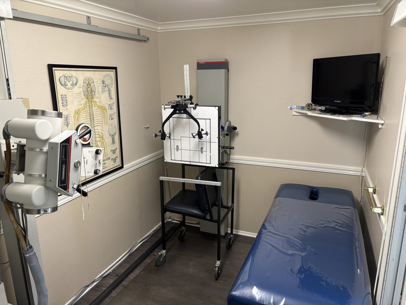 X-ray room with imaging equipment and a table